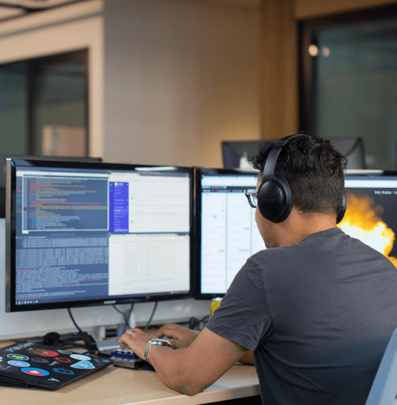 man wearing headphones working on computer